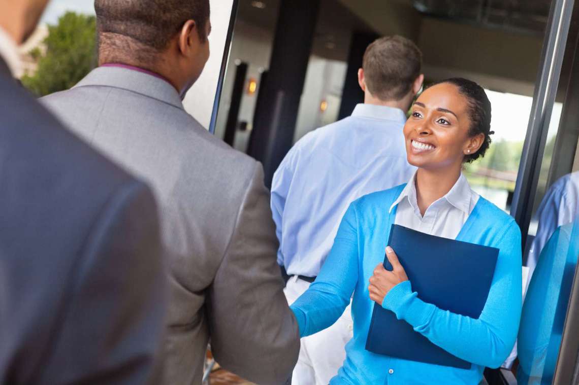 Woman greeting a man at a business event